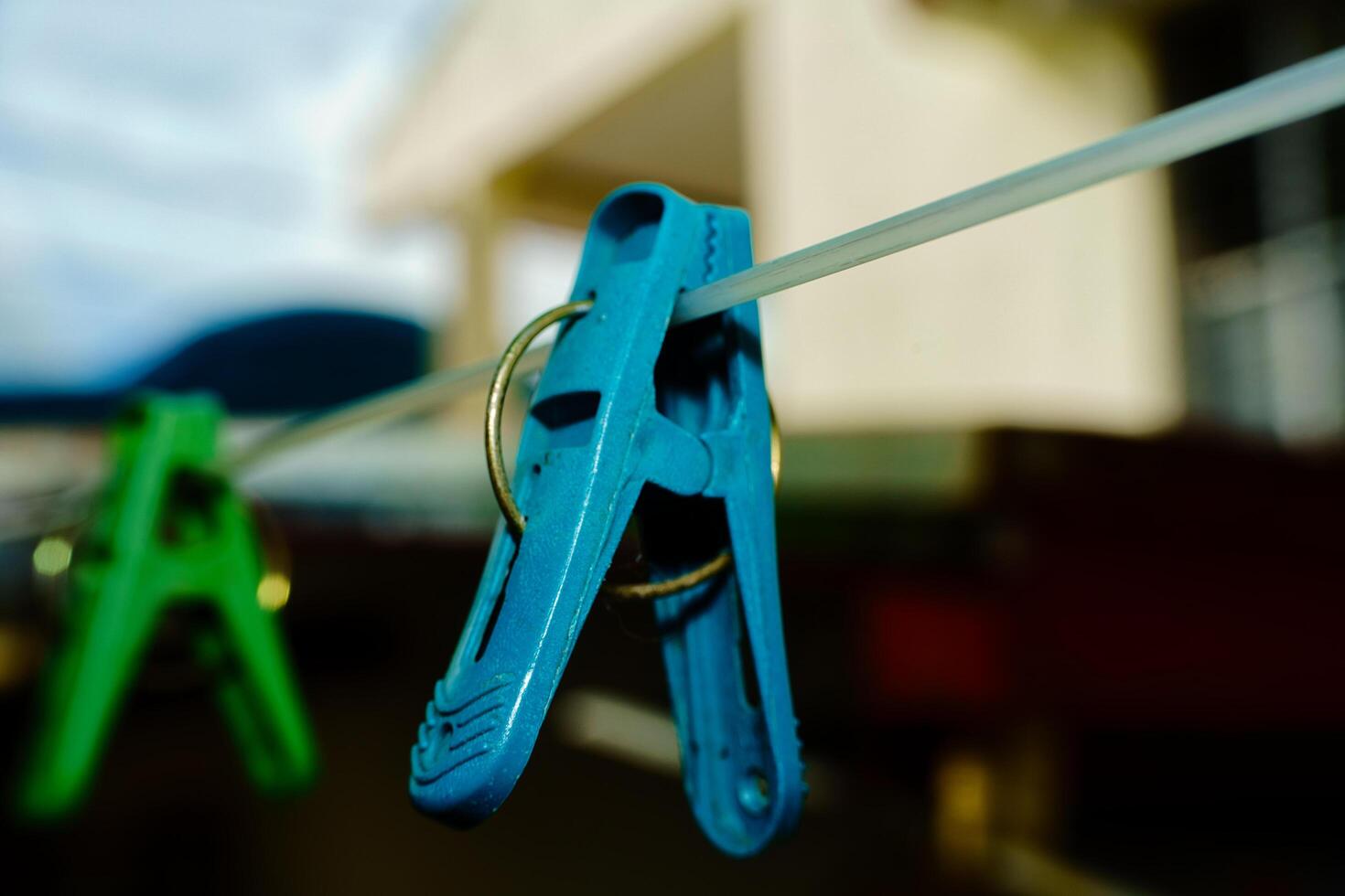 a pair of blue and green clippers hanging on a clothesline photo