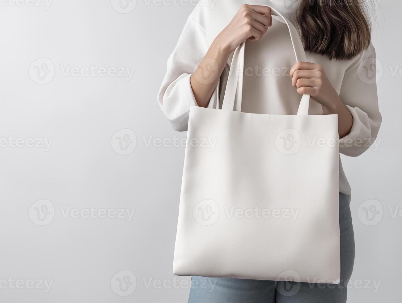 woman holding a blank canvas tote bag for mockup photo