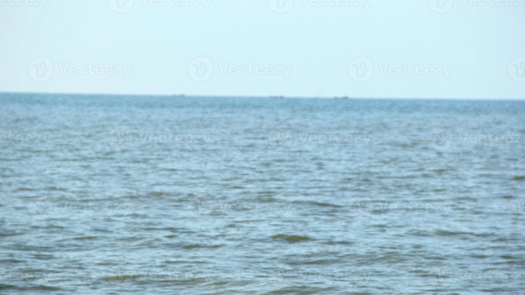 This beach with brown water that has been polluted by rubbish looks beautiful in the afternoon photo