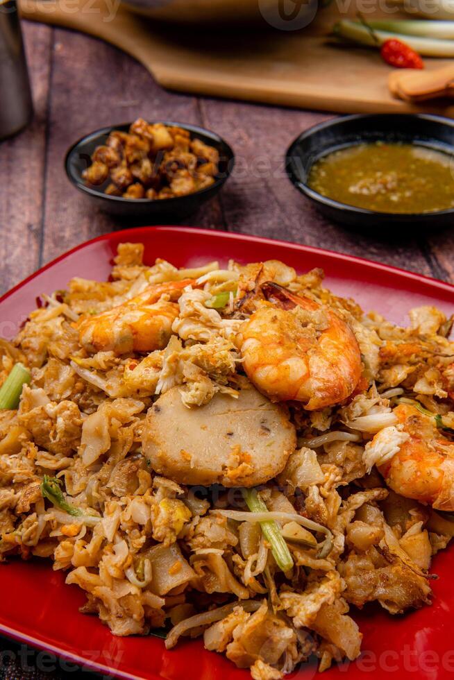 Kwetiau goreng medan or char kway teow It is made from noodles, which are stir fried in cooking oil with garlic, onion or shallots, pork, fried prawn, sliced bakso photo