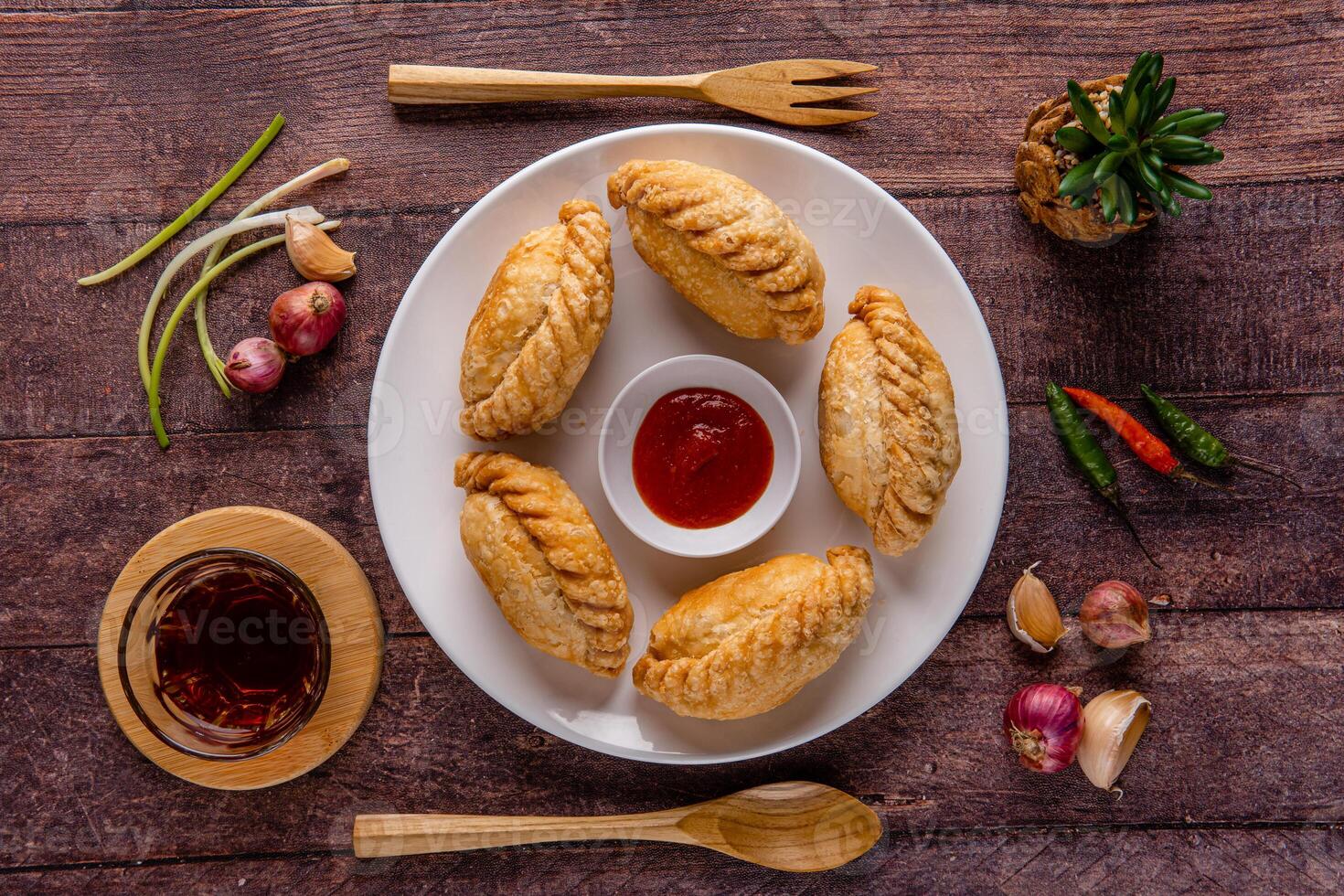 Curry puff or Pastel goreng. it is a small pie consisting of curry with chicken and potatoes in a deep fried or baked pastry shell photo