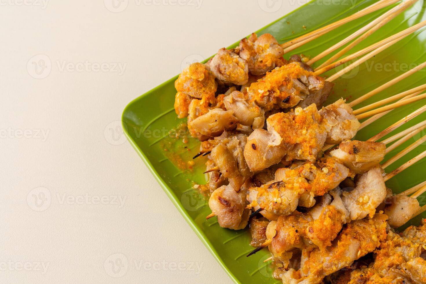 Sate taichan or Taichan satay with grilled chicken skin is a variation of chicken satay grilled and served without peanut or ketchup served with chili sauce. photo