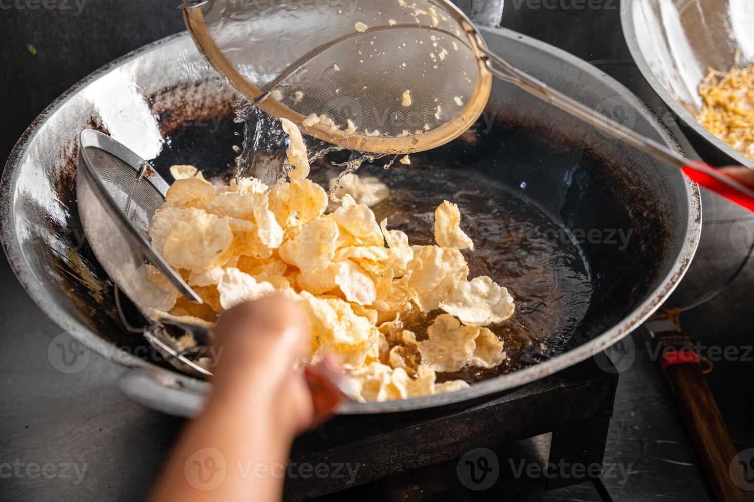 making process Emping Balado, Spicy Snacks from West Sumatra. Made from melinjo crackers, it's crunchy and sweet and spicy. photo