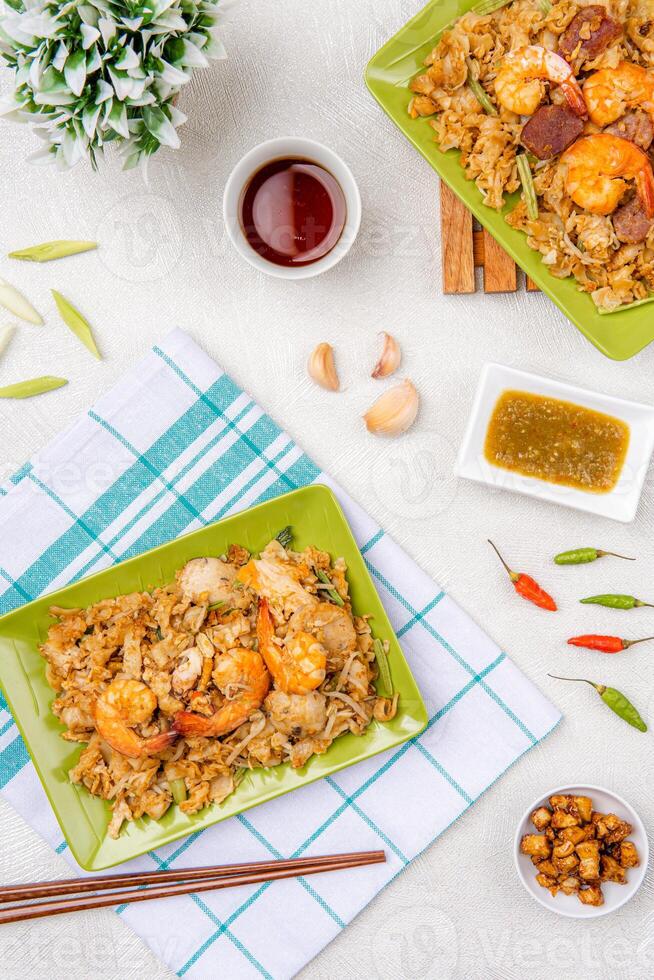 Kwetiau goreng medan or char kway teow It is made from noodles, which are stir fried in cooking oil with garlic, onion or shallots, pork, fried prawn, sliced bakso photo