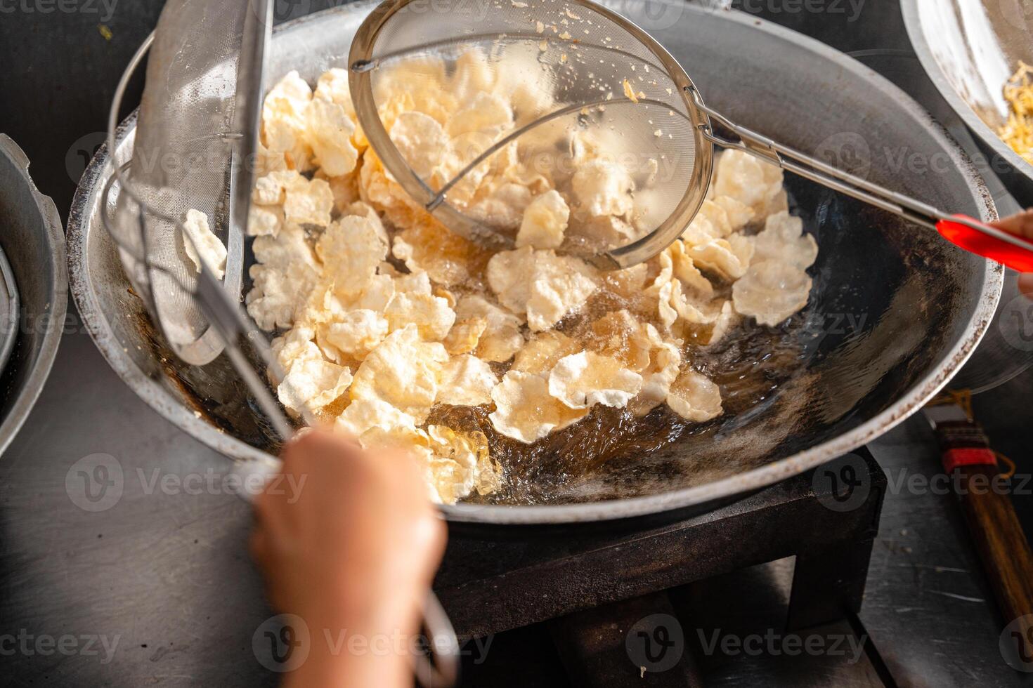 making process Emping Balado, Spicy Snacks from West Sumatra. Made from melinjo crackers, it's crunchy and sweet and spicy. photo