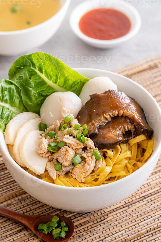 Bak chor mee. The noodles are tossed in vinegar, minced meat, pork slices, pork liver, stewed sliced mushrooms, meat balls and bits of deep-fried lard photo