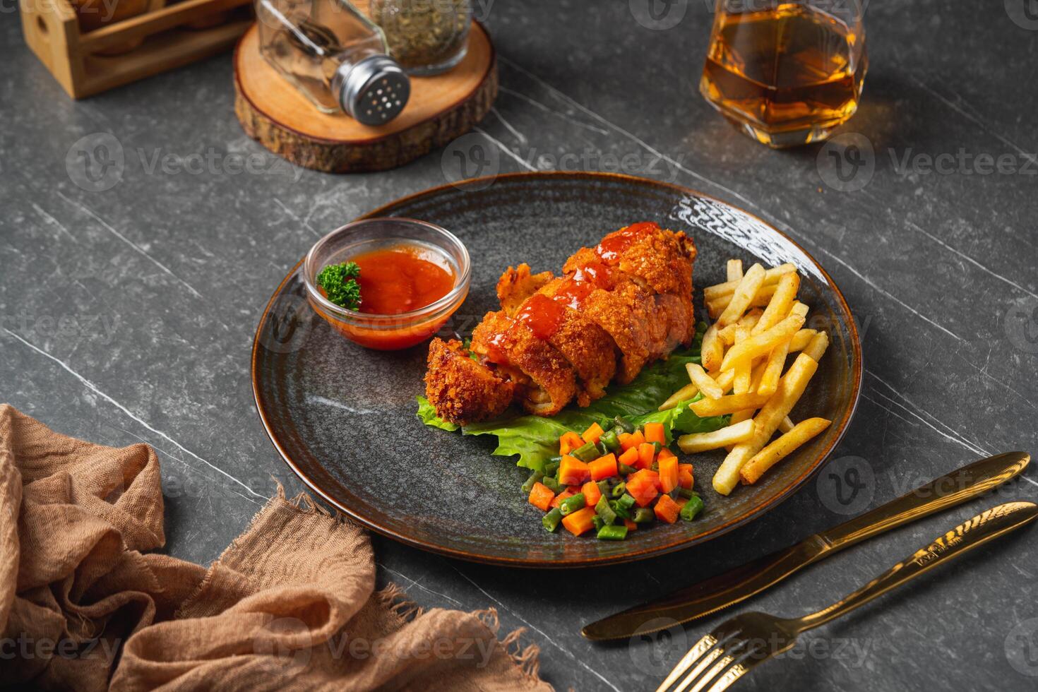 A chicken cordon bleu or schnitzel cordon bleu is a dish of meat wrapped around cheese, then breaded and pan-fried or deep fried. photo