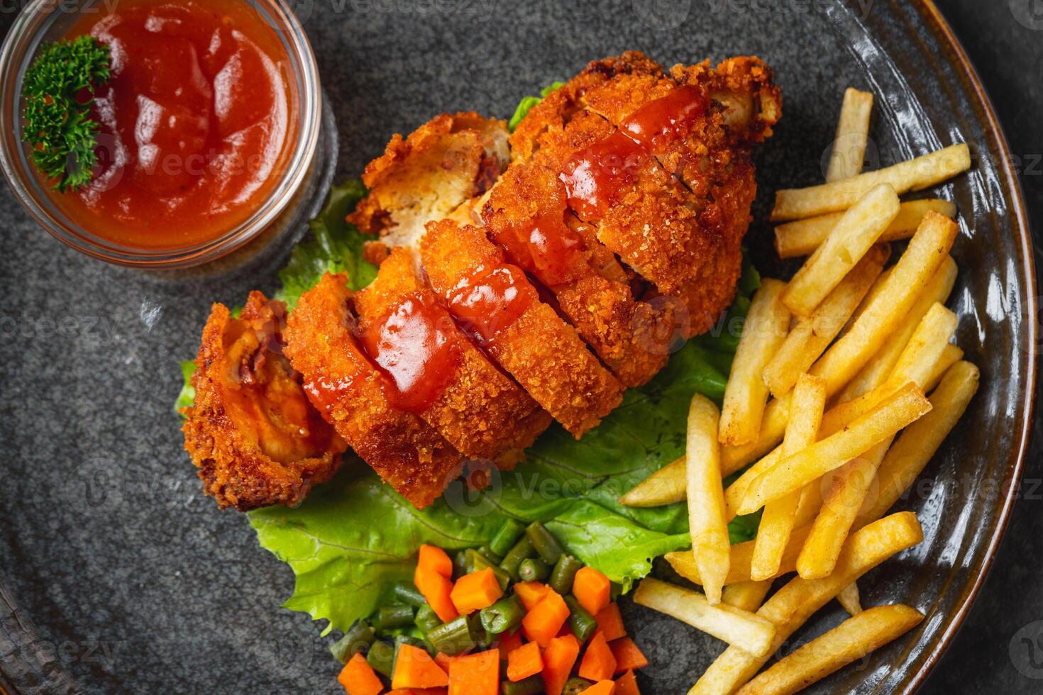 A chicken cordon bleu or schnitzel cordon bleu is a dish of meat wrapped around cheese, then breaded and pan-fried or deep fried. photo