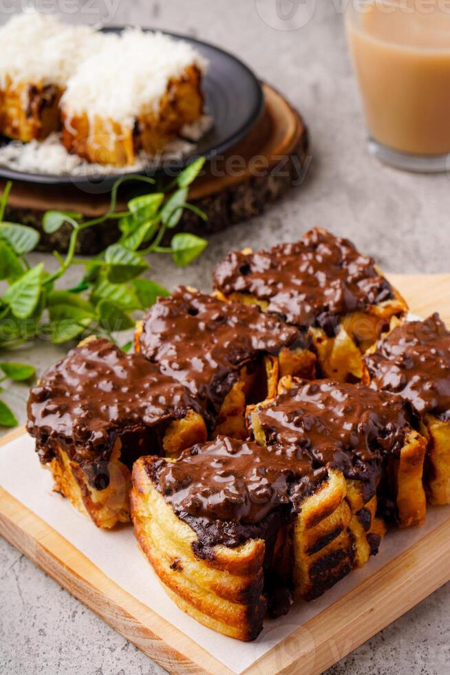 Roti Bakar Bandung or Bandung Bread Toast is Popular Street Food from Bandung. Roti bakar refers to toast, served often with butter, cheese, stwarberry jam, Green tea, crushed peanuts and sugar, photo