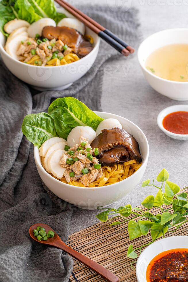 Bak chor mee. The noodles are tossed in vinegar, minced meat, pork slices, pork liver, stewed sliced mushrooms, meat balls and bits of deep-fried lard photo