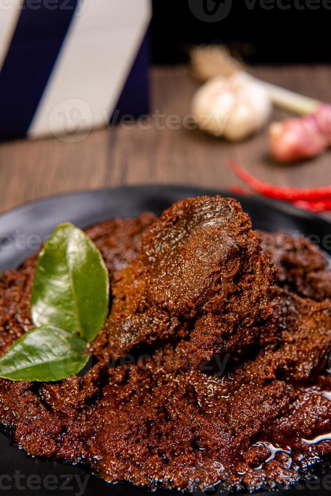Beef Rendang is a Minang dish originating from the Minangkabau region in West Sumatra, Indonesia. Rendang has been slow cooked and braised in a coconut milk seasoned with a herb and spice mixture photo