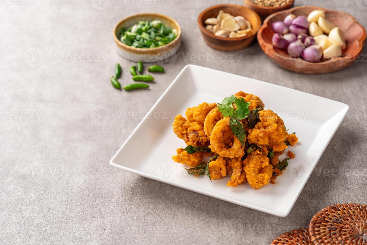 Stir Fried Squid with Salted Egg Yolk plating on white plate. photo