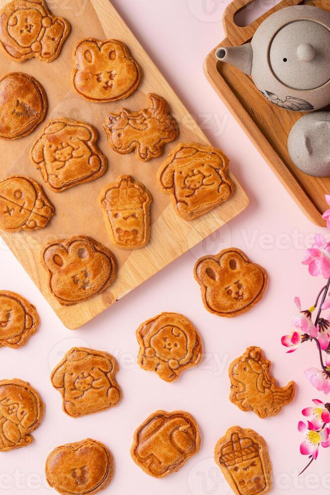 Mooncake biscuits are little sweet snacks which are like the outer layer of the mooncake. Unlike the traditional baked mooncakes, these biscuits are usually made without filling and are much thicker. photo