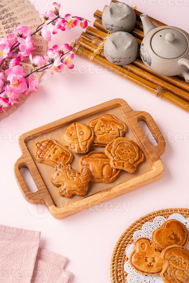 Mooncake biscuits are little sweet snacks which are like the outer layer of the mooncake. Unlike the traditional baked mooncakes, these biscuits are usually made without filling and are much thicker. photo