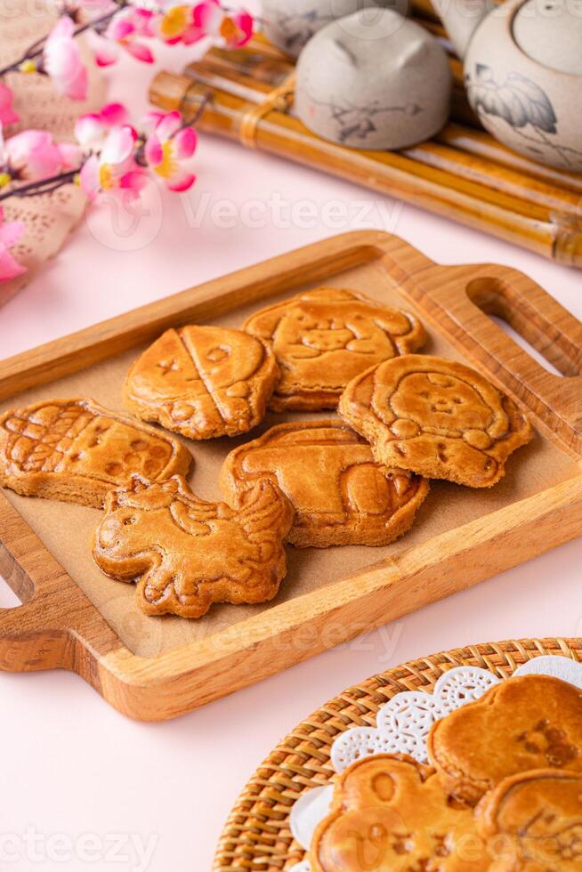 Mooncake biscuits are little sweet snacks which are like the outer layer of the mooncake. Unlike the traditional baked mooncakes, these biscuits are usually made without filling and are much thicker. photo