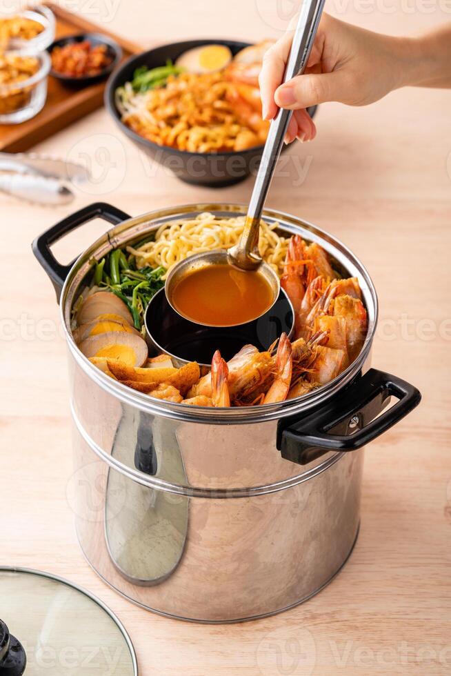 Hokkien mee or Prawn noodle are tossed in pork lard and served with fish balls, shrimp. photo