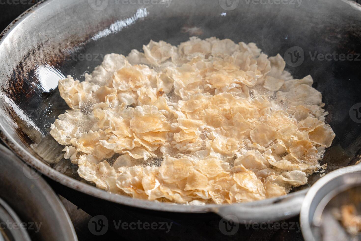 making process Emping Balado, Spicy Snacks from West Sumatra. Made from melinjo crackers, it's crunchy and sweet and spicy. photo