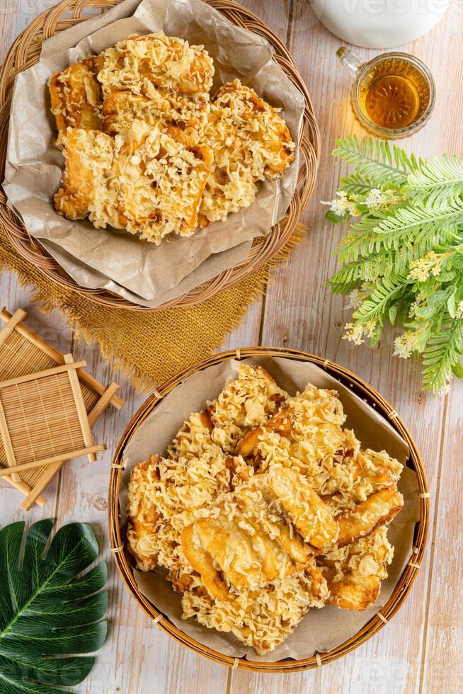 Pisang goreng Coklat Keju is a fritter made by deep frying battered plantain in hot oil. The batter most commonly uses a combination of flour, either wheat, rice flour, tapioca or bread crumb. photo