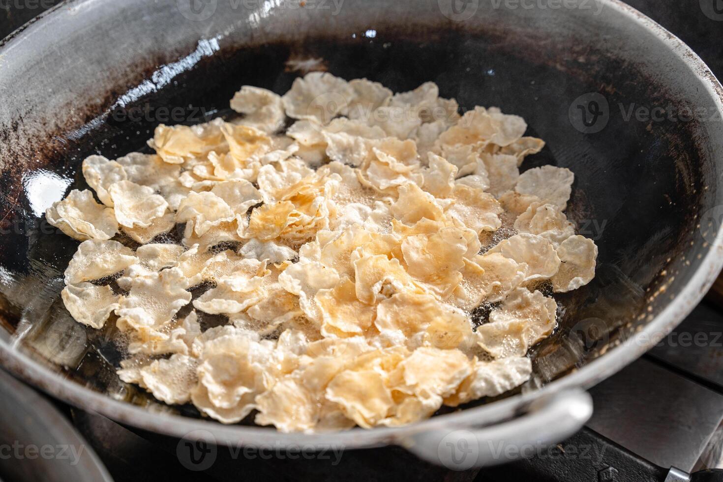 making process Emping Balado, Spicy Snacks from West Sumatra. Made from melinjo crackers, it's crunchy and sweet and spicy. photo