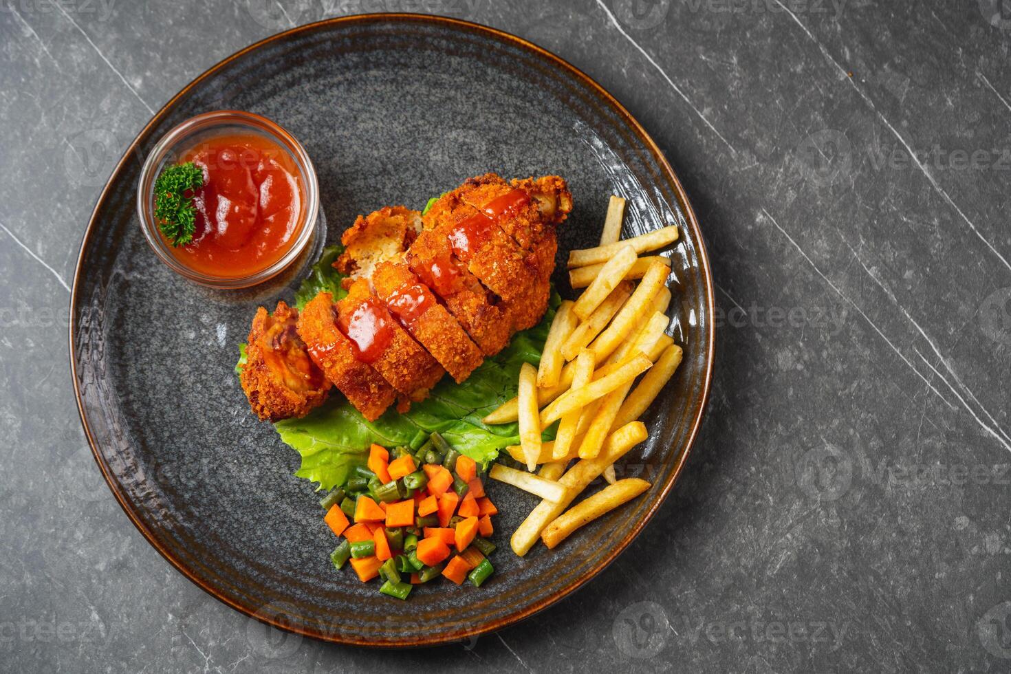 A chicken cordon bleu or schnitzel cordon bleu is a dish of meat wrapped around cheese, then breaded and pan-fried or deep fried. photo