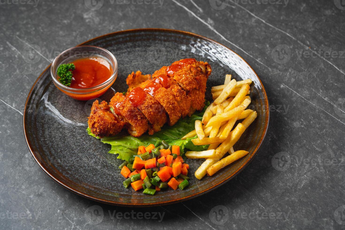 A chicken cordon bleu or schnitzel cordon bleu is a dish of meat wrapped around cheese, then breaded and pan-fried or deep fried. photo