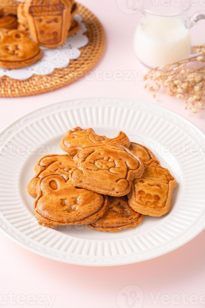 Mooncake biscuits are little sweet snacks which are like the outer layer of the mooncake. Unlike the traditional baked mooncakes, these biscuits are usually made without filling and are much thicker. photo