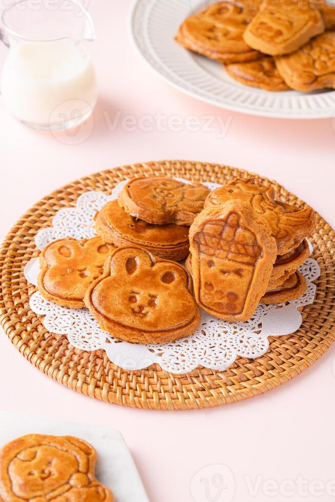 Mooncake biscuits are little sweet snacks which are like the outer layer of the mooncake. Unlike the traditional baked mooncakes, these biscuits are usually made without filling and are much thicker. photo