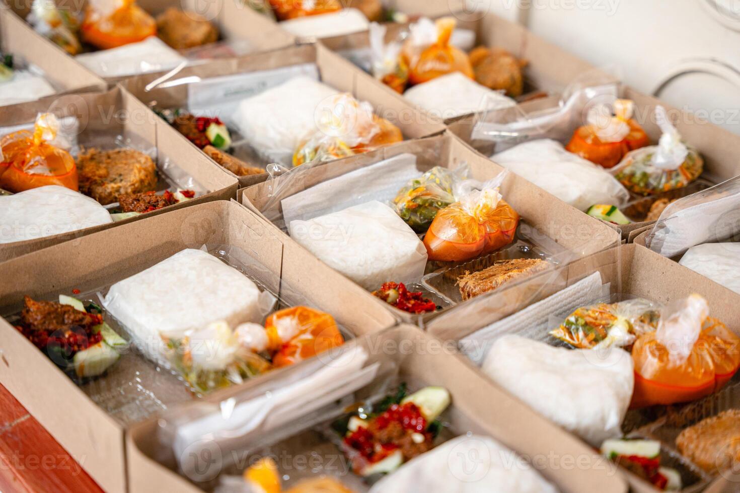 In Indonesian it is called Rice Box or Nasi kotak with perkedel kentang. Usually distributed during celebrations or catering packaging. photo