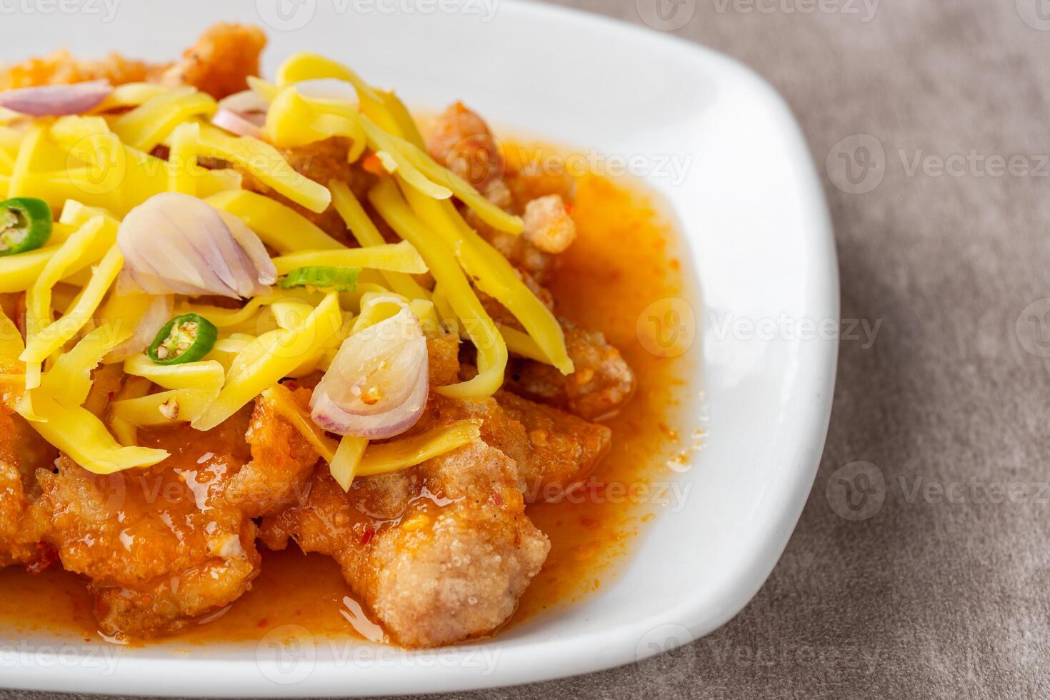 crispy chicken with mango sauce or Ayam Saus Mangga. The taste is savory spicy and a little sweet. photo