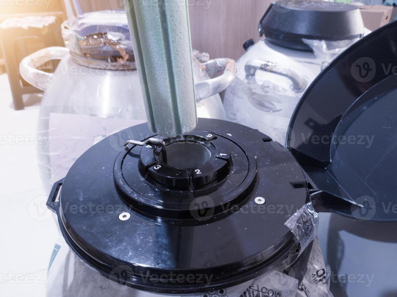 Open the liquid nitrogen containers for vaccine containers. photo