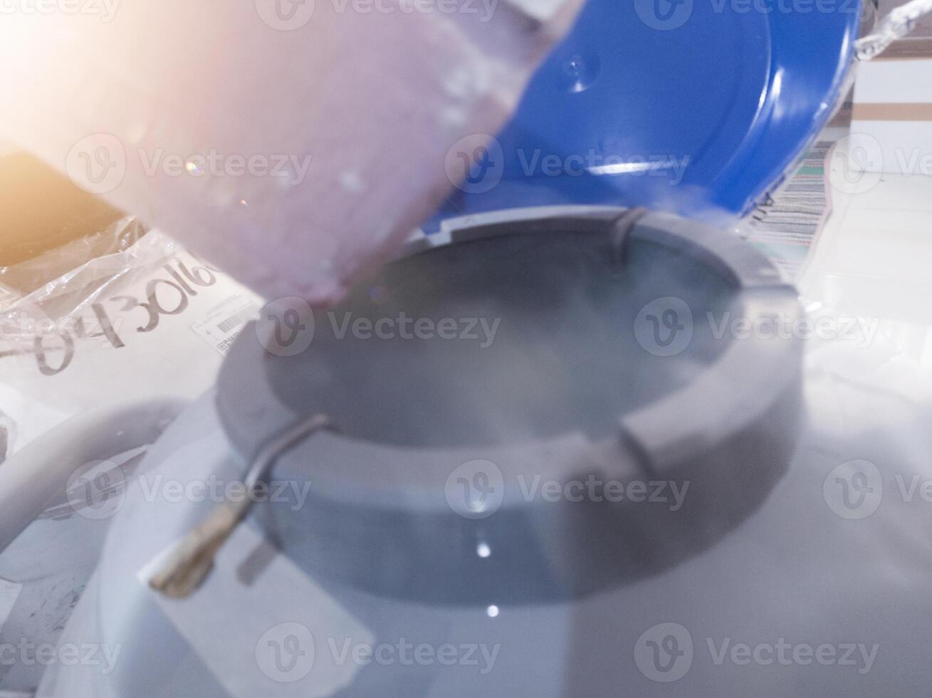 Open the liquid nitrogen containers for vaccine containers. photo