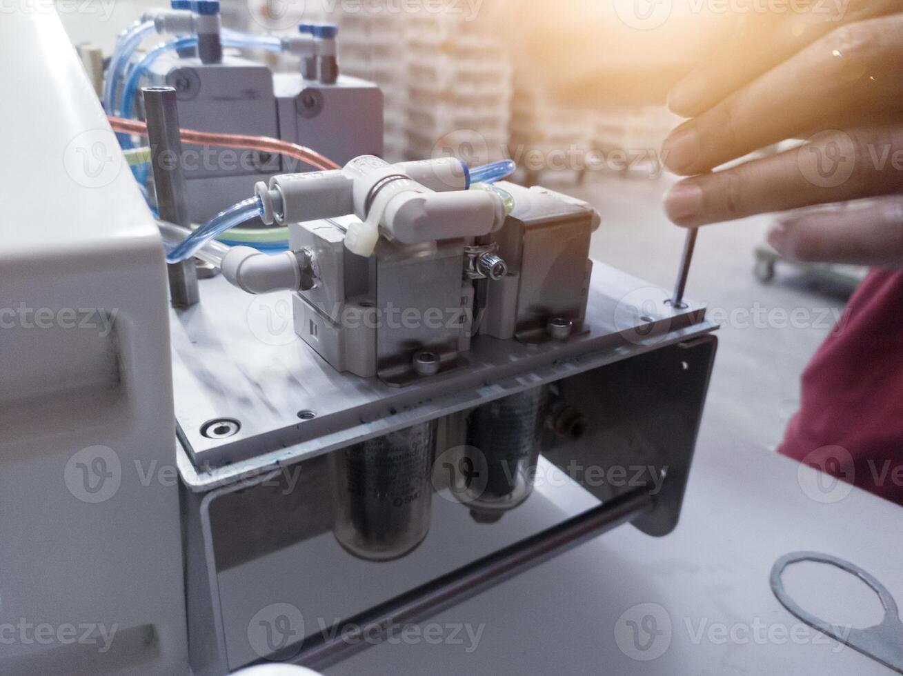 Vaccinator repair and service the vaccine injector machine. photo
