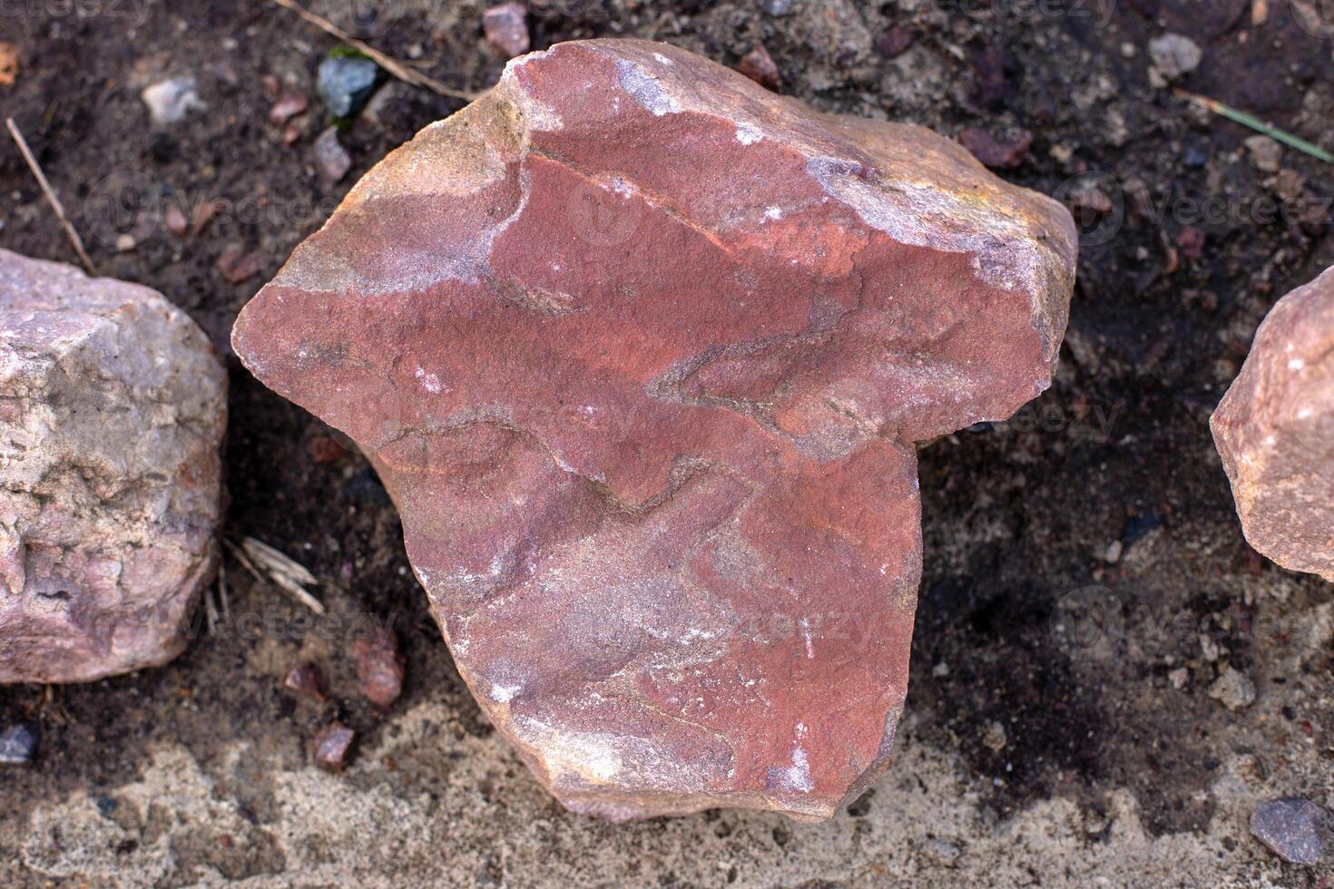 Pink sandstone stone on the dark ground. photo