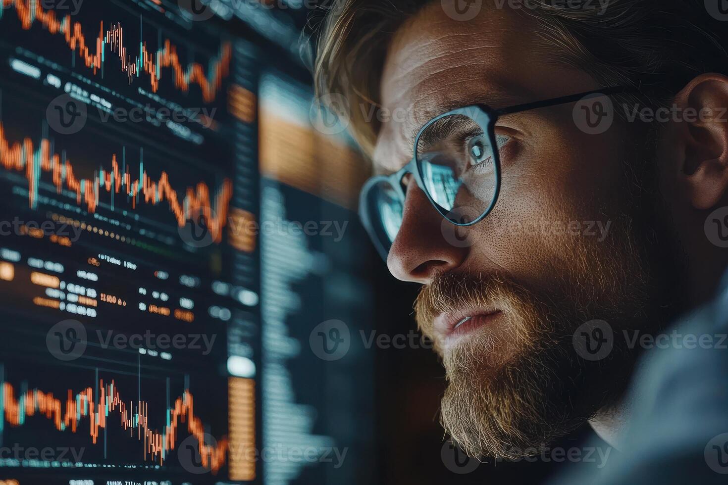 Focused analyst reviewing financial data at night photo