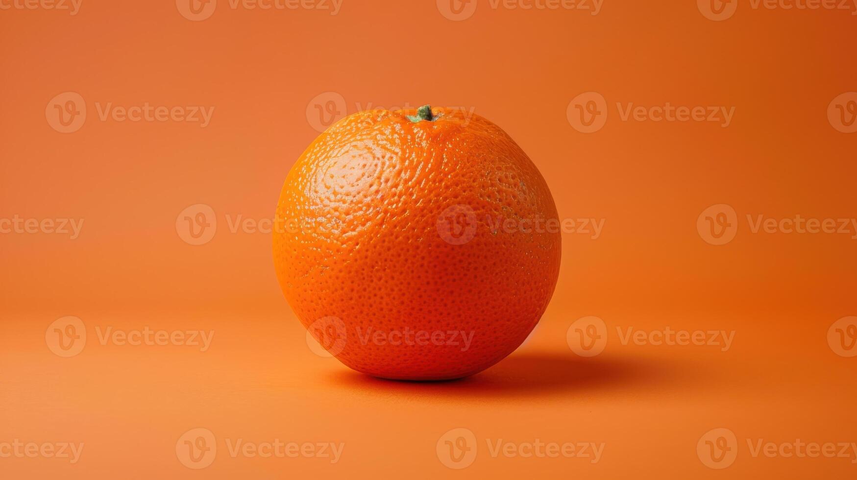 A Single Orange Against a Sunset-Colored Background photo