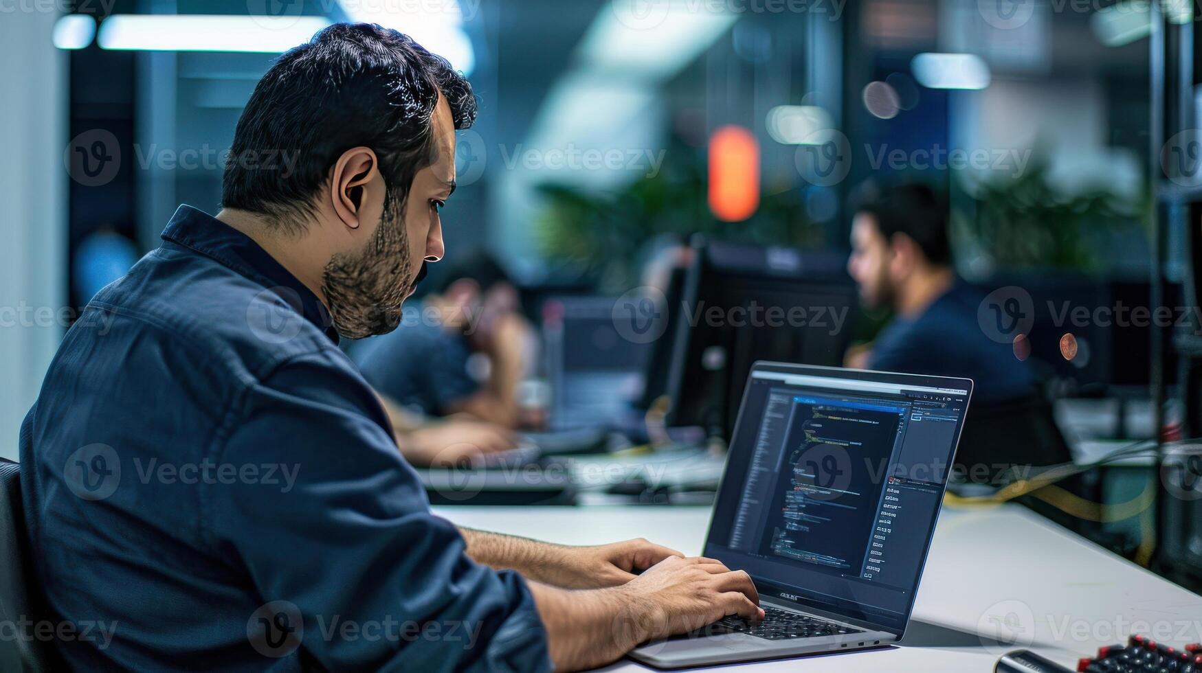 A Focused Programmer Works Late Into the Night in a Modern Office photo