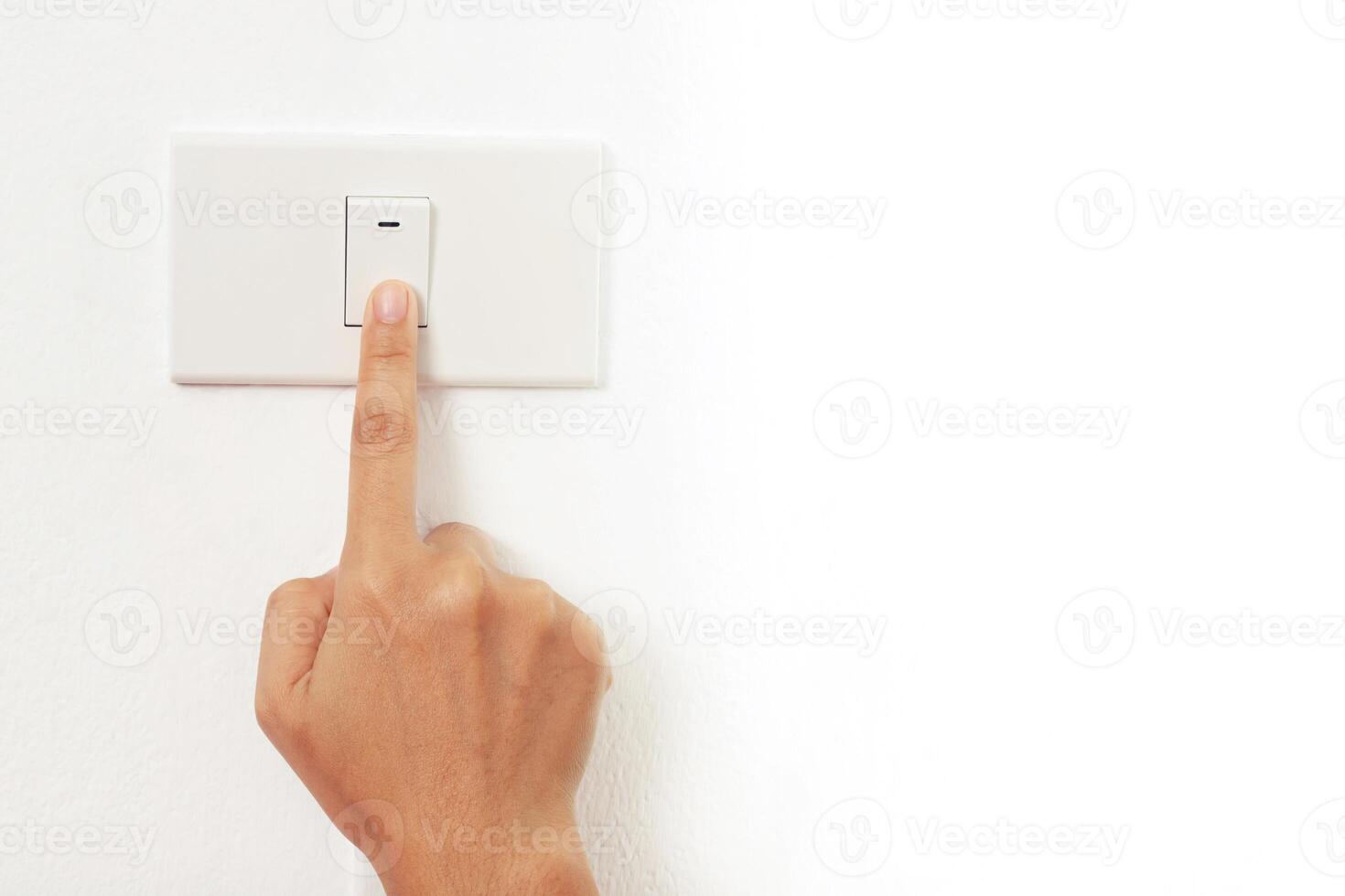 Turn off the light, close up female hand is closing the power switch. Save energy, reduce global warming. photo