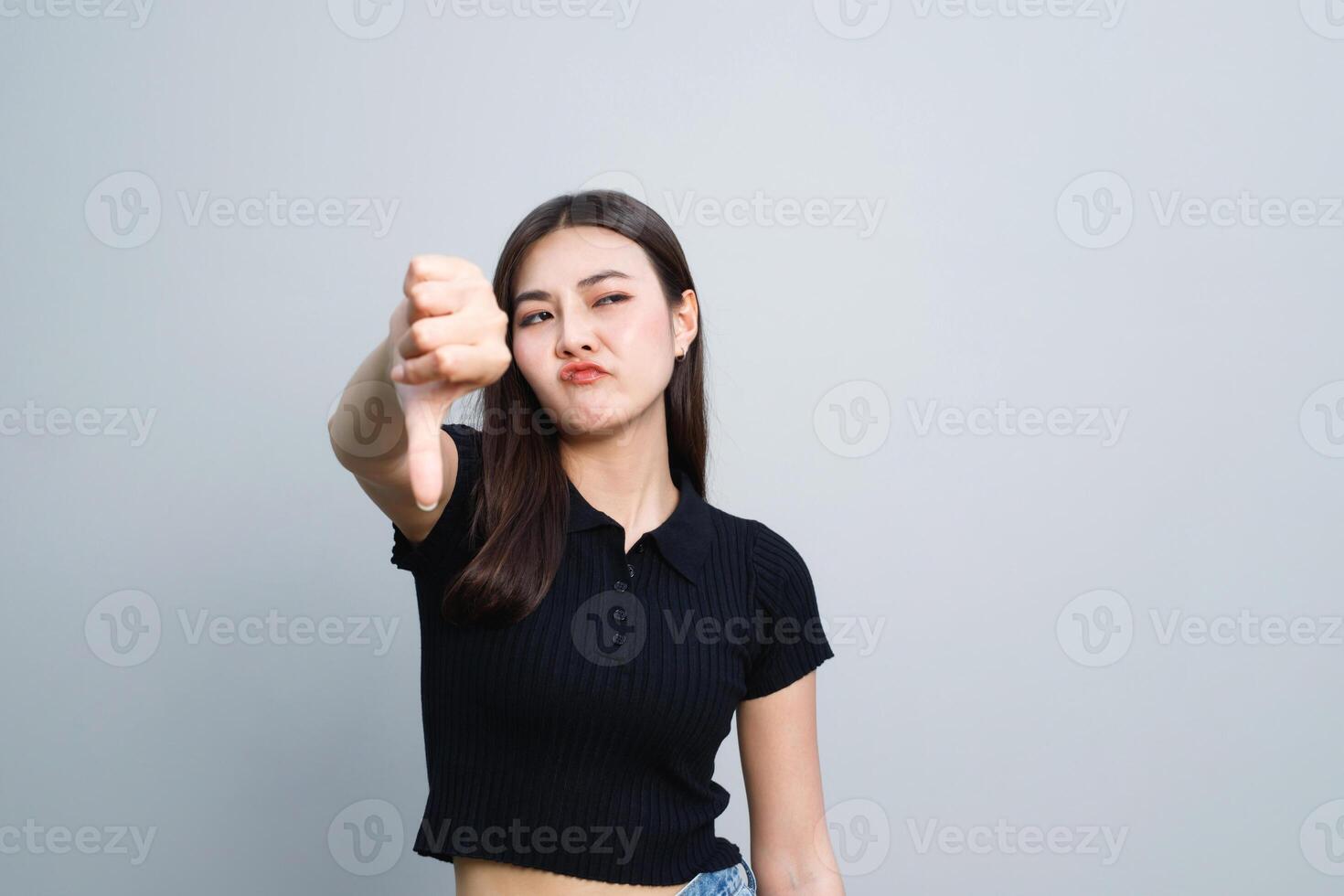 Model asian woman is emotional bad showing dissatisfaction, thumbs down photo