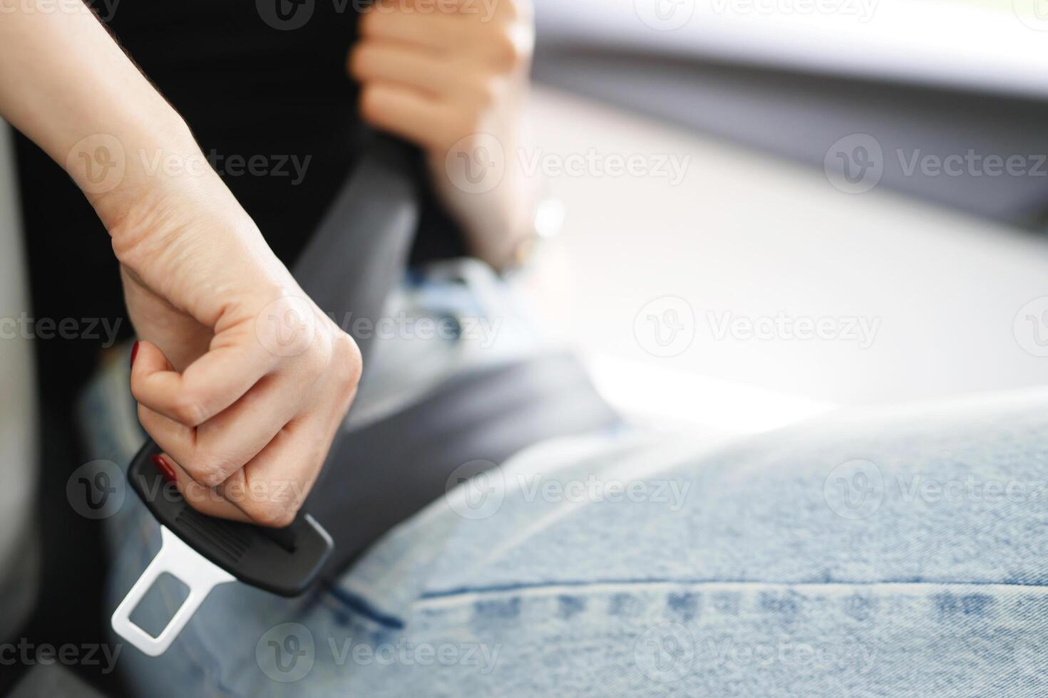 Close Up of people business woman hand fastening seat safety belt in car for safety before driving on the road. concept transport travel. soft focus. photo