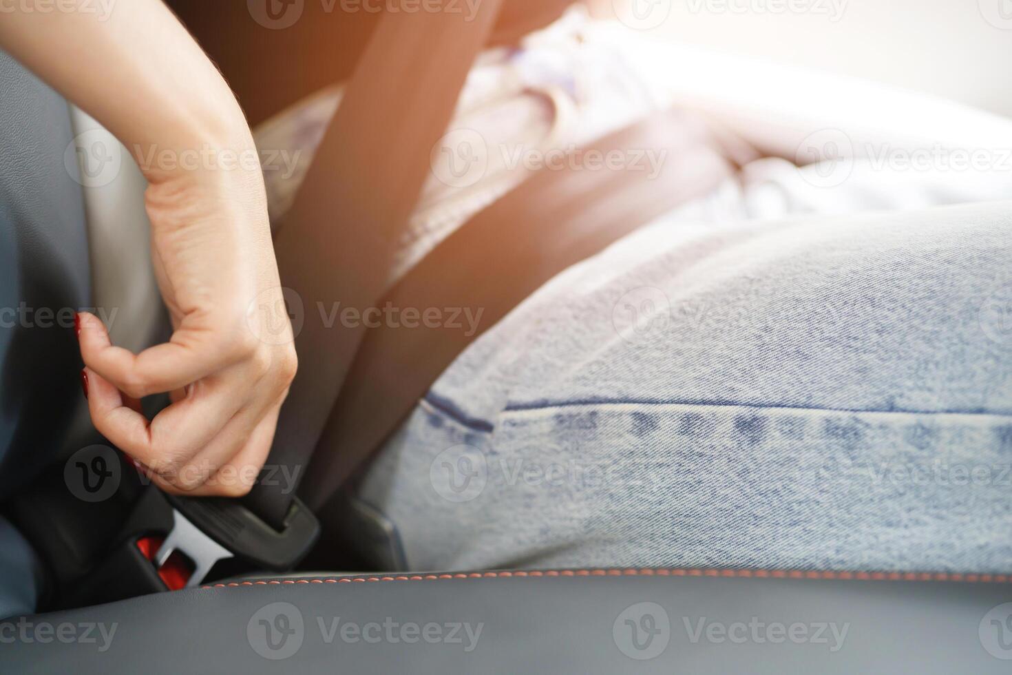 Close Up of people business woman hand fastening seat safety belt in car for safety before driving on the road. concept transport travel. soft focus. photo
