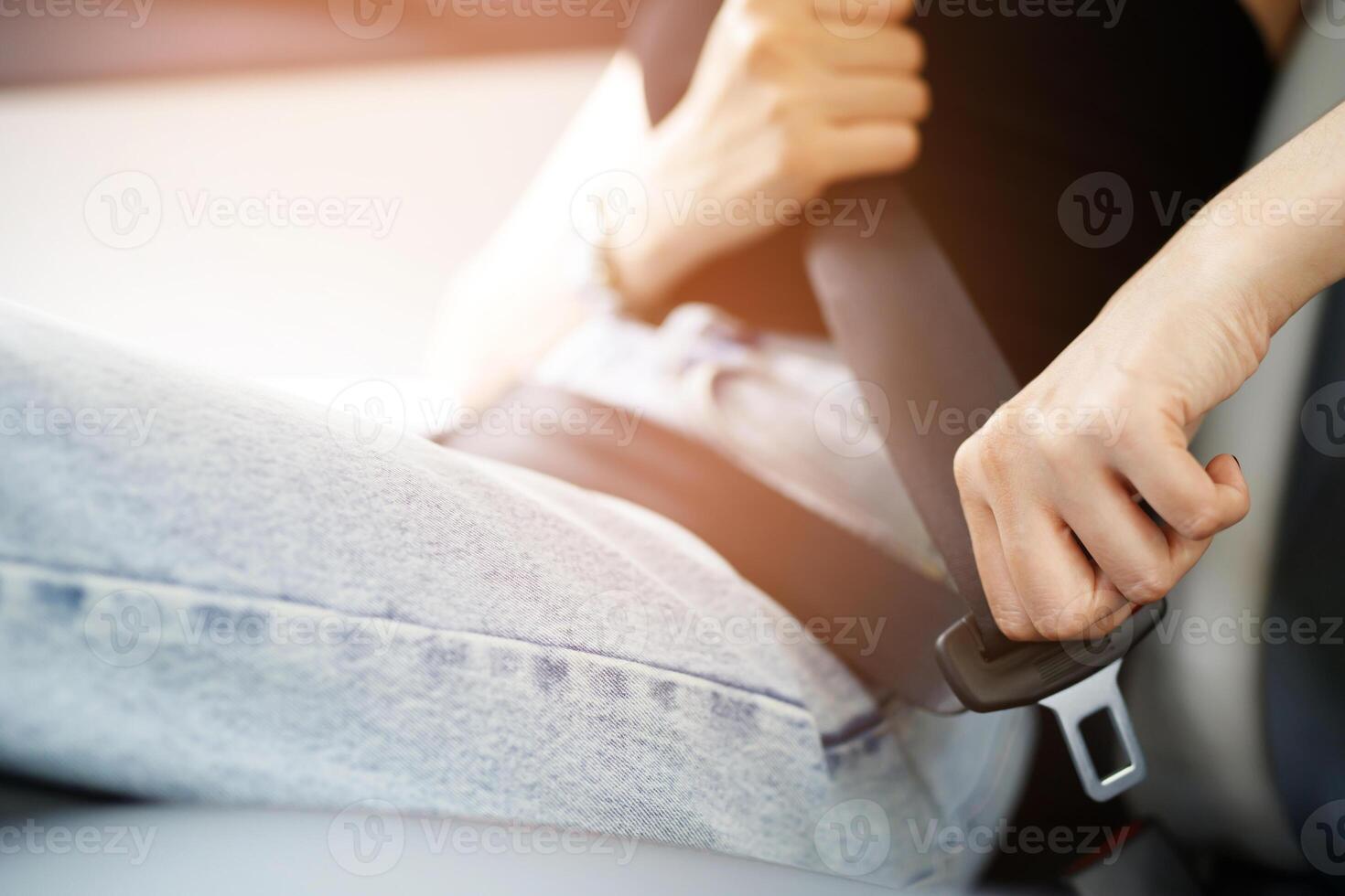 Close Up of people business woman hand fastening seat safety belt in car for safety before driving on the road. concept transport travel. soft focus. photo