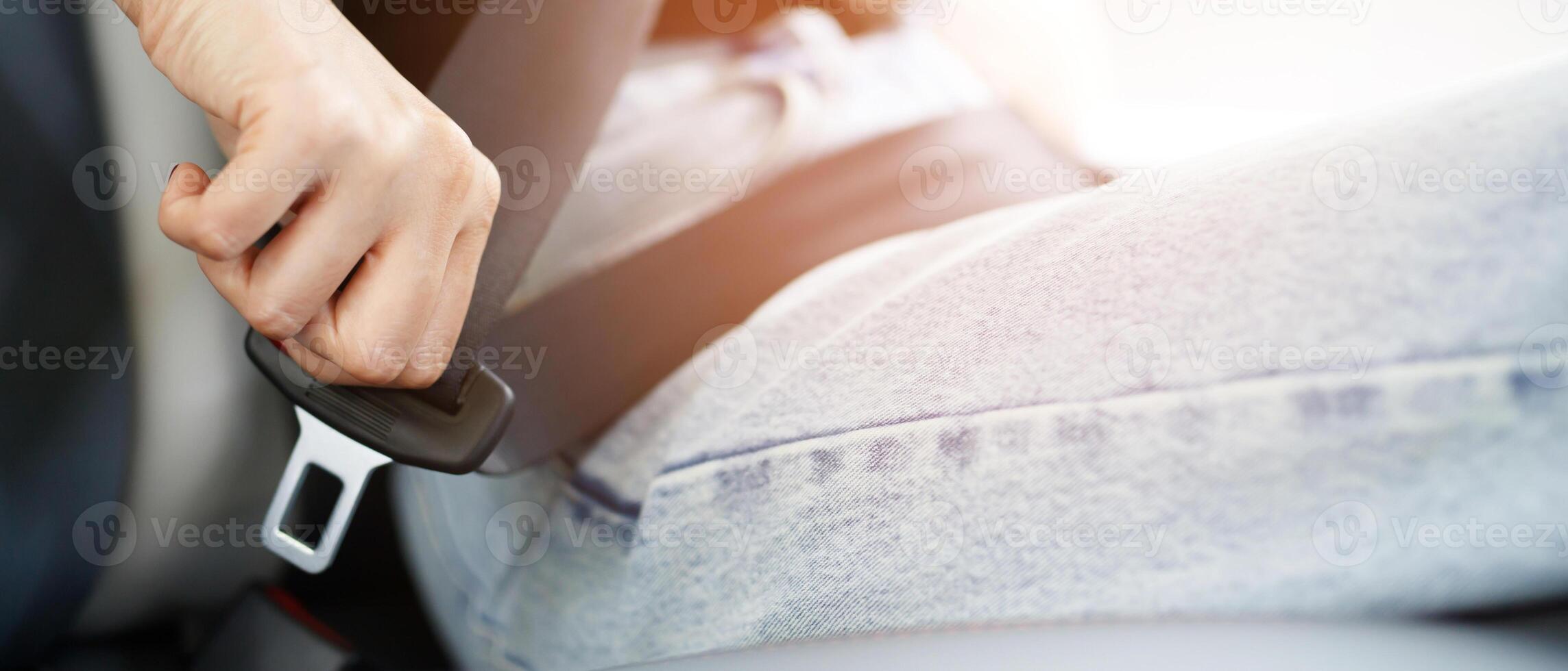 Close Up of people business woman hand fastening seat safety belt in car for safety before driving on the road. concept transport travel. soft focus. photo