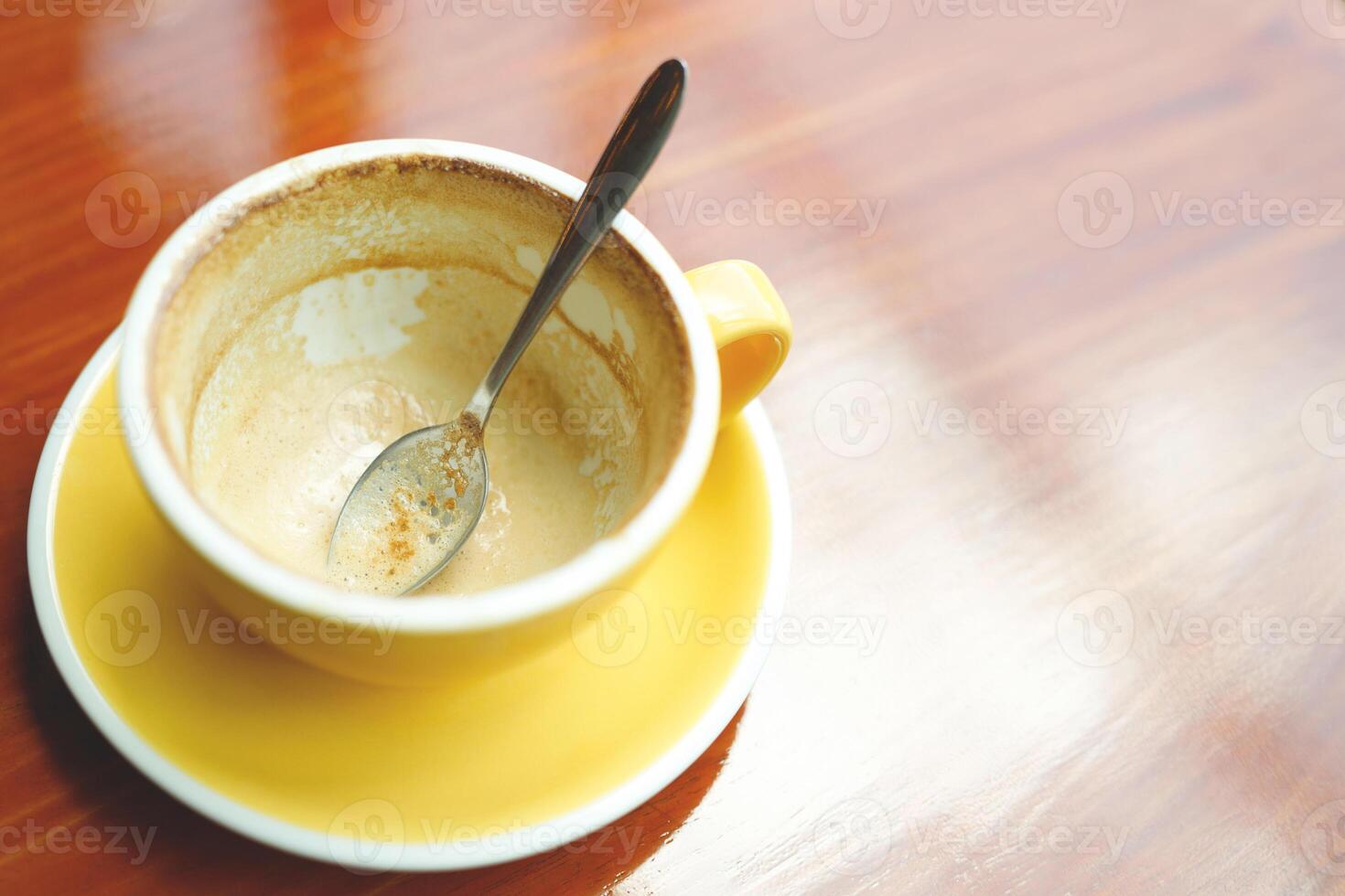 An empty cup of coffee is placed on the table. photo