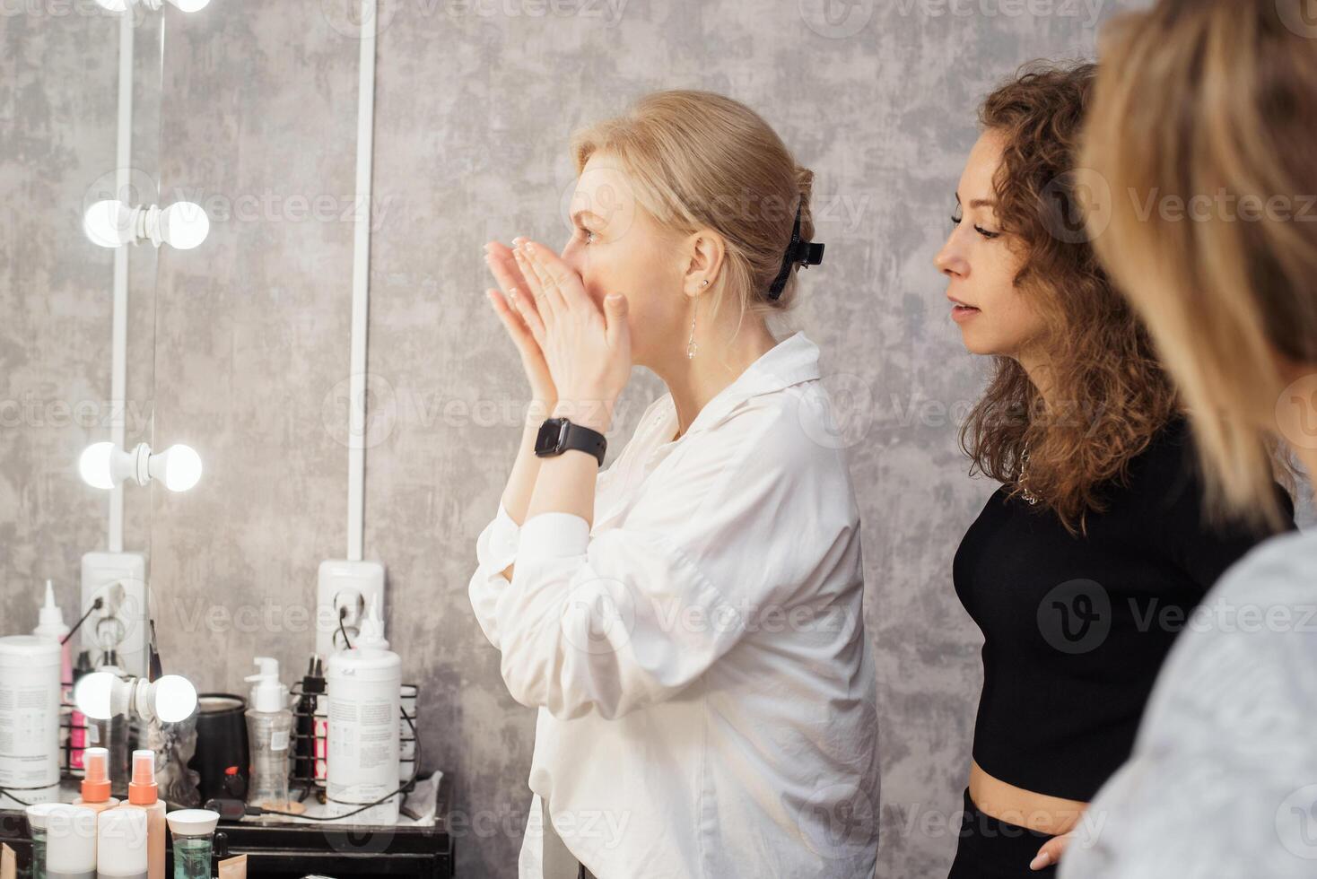 A professional makeup artist conducts a master class on professional development showing makeup practices photo
