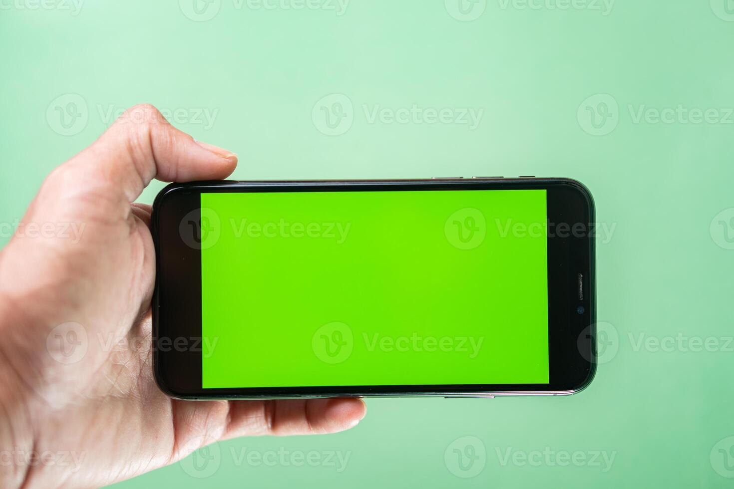 Smart phone with Green Screen in Hand photo