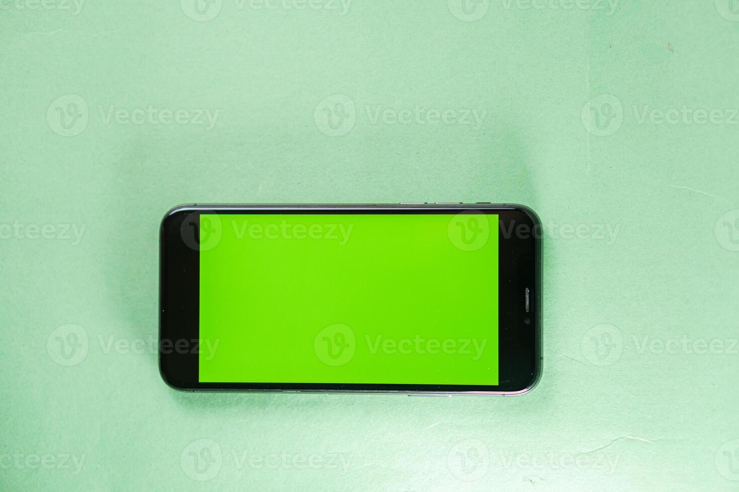Smart phone with Green Screen on Light Background photo