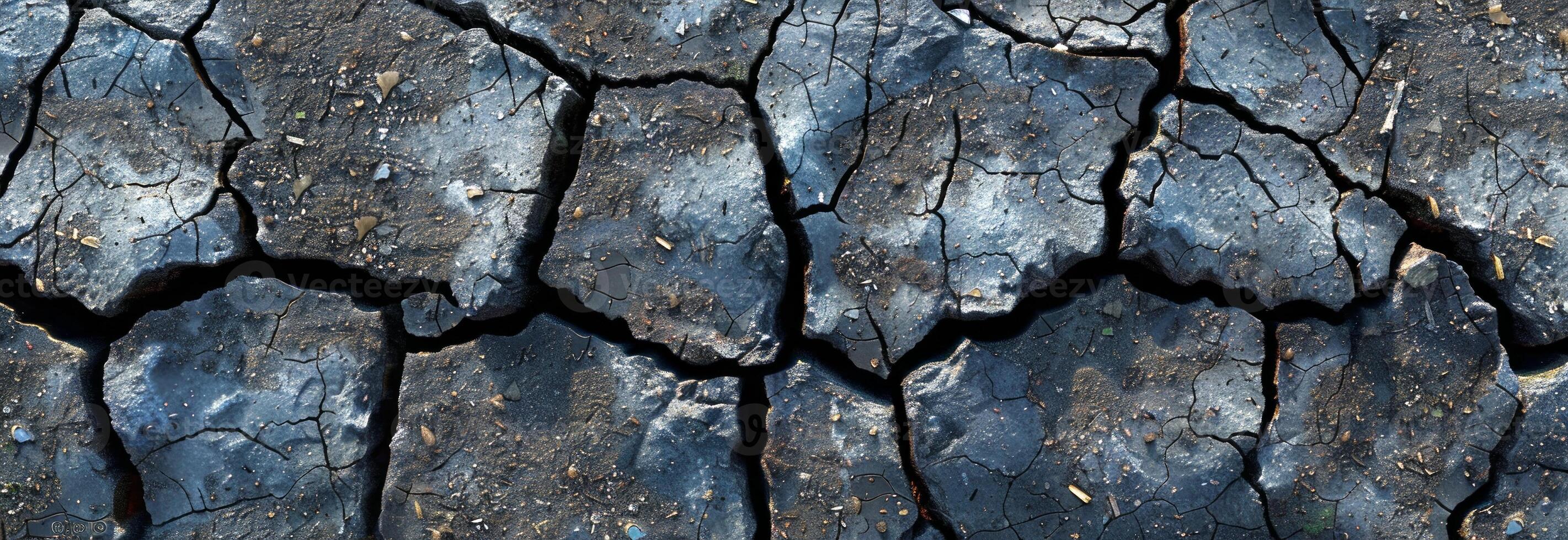 Close-up of cracked, dry earth on a sunny day. Concept of drought, environmental impact, climate change, and soil degradation. Banner photo