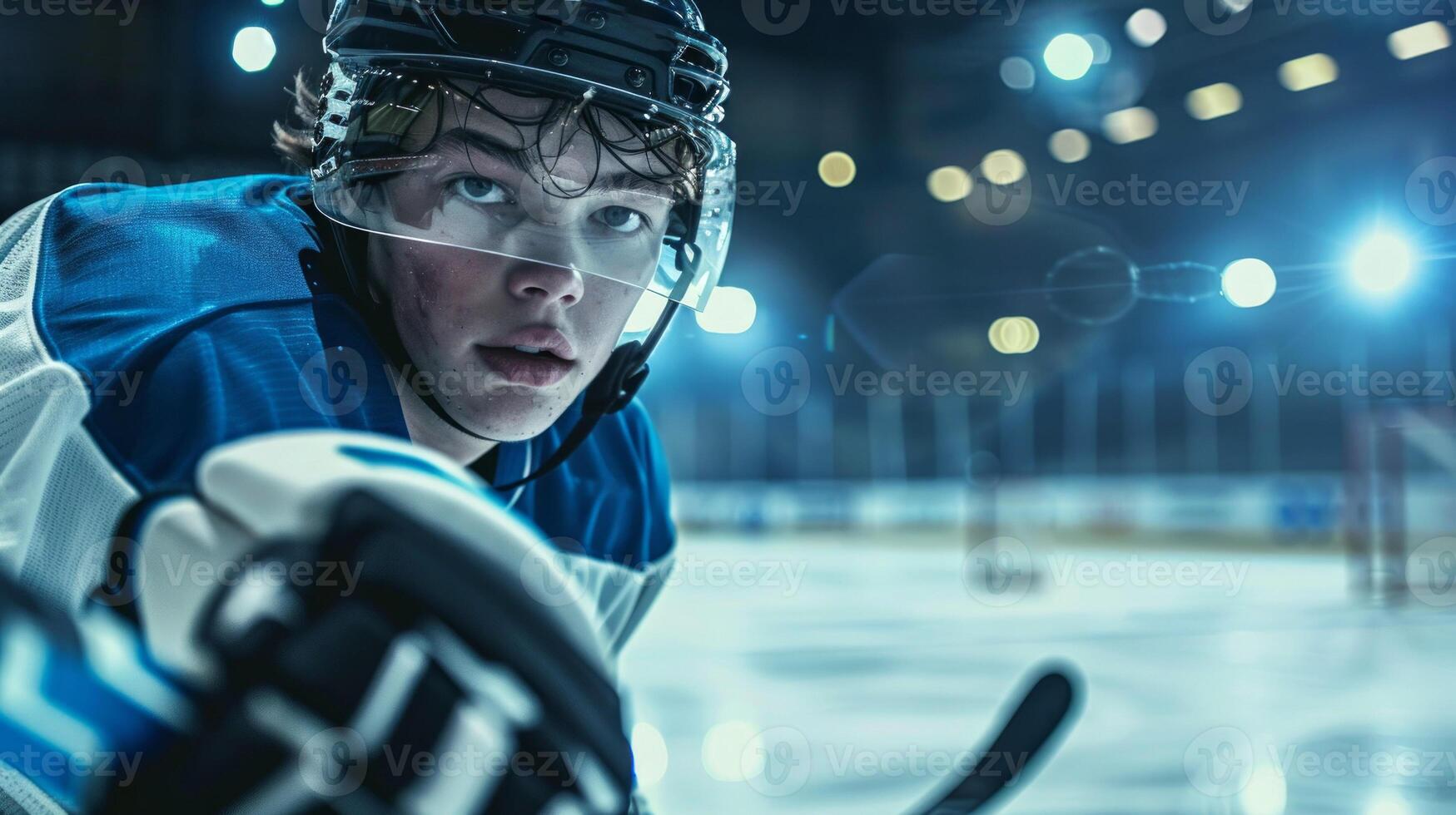 Focused Hockey Player in White and Blue Jersey During Intense Game in a Stadium. Concept of Competitive Sports, Athletic Determination, Professional Hockey, Game Focus photo