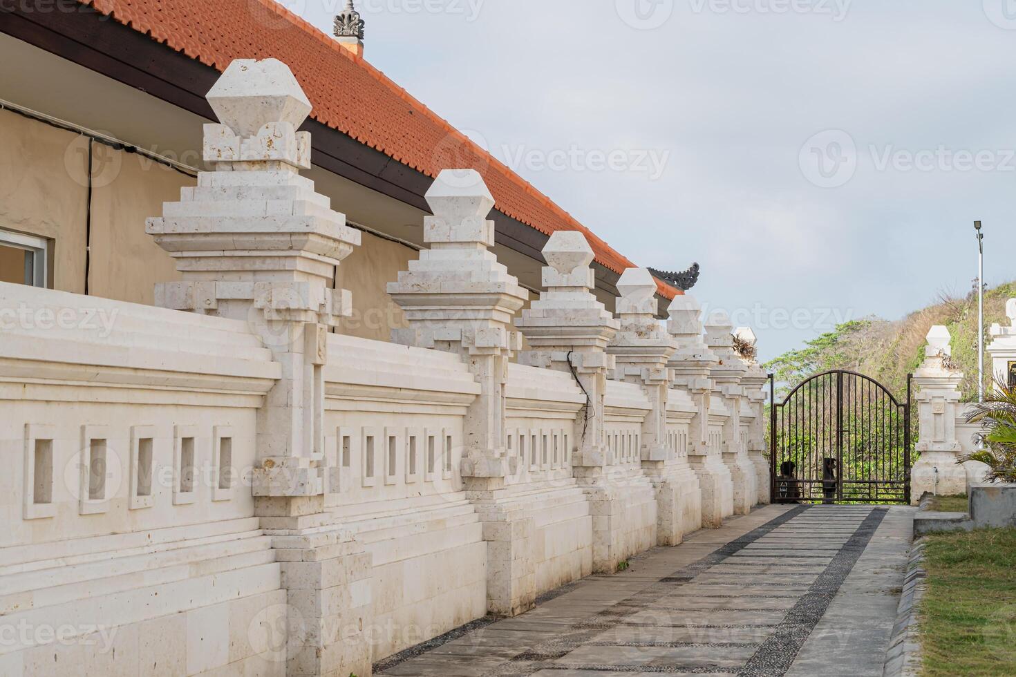 A white building with a red roof photo