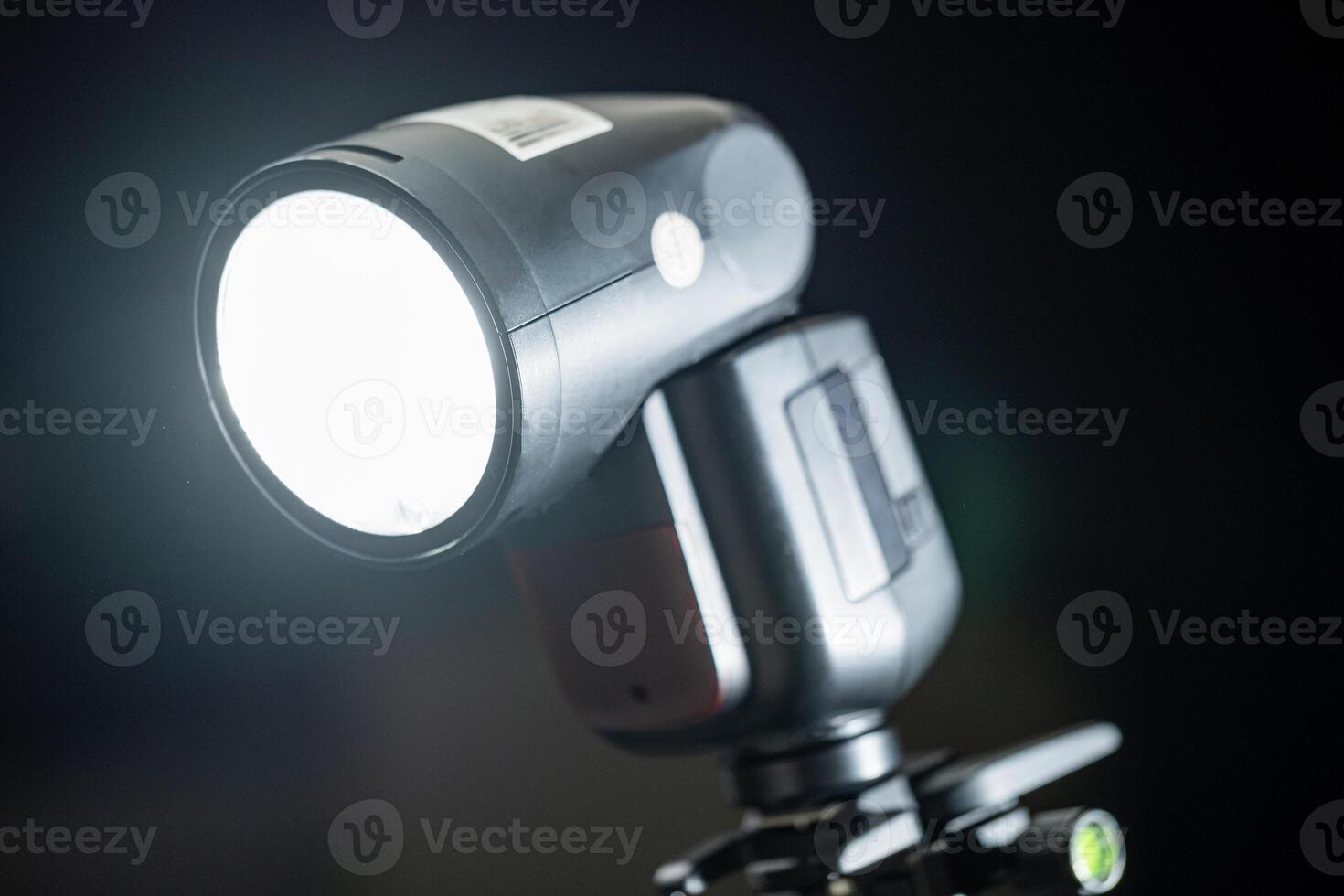 A flash light is on a tripod with a light on it photo